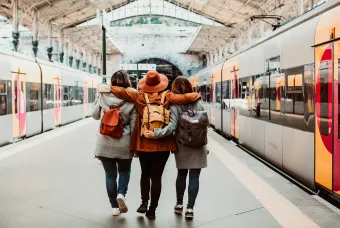 vrienden bij treinstation met rugzak
