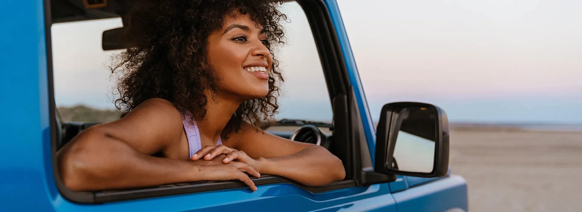 woman passenger looking out of blue car 
