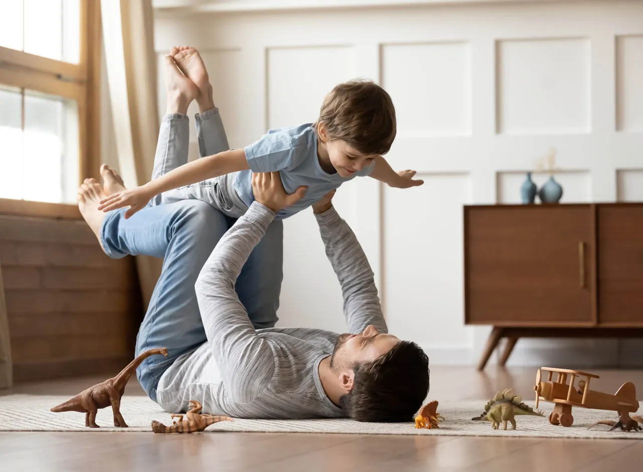 time dad son at play aeroplane dinosaurs 